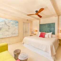 Bedroom with ceiling fan and artwork — Casa Cielo, Isla Mujeres, Mexico
