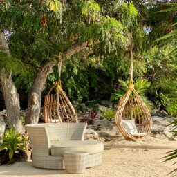 Beachfront lounge with hanging chairs — Casa Coco, Isla Mujeres, Mexico