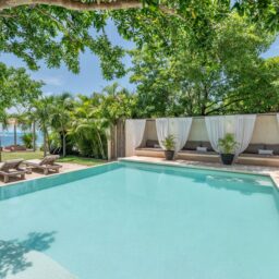 Pool and garden with ocean glimpse — Casa Coco, Isla Mujeres, Mexico