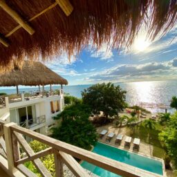 Balcony view over the pool and ocean — Casa Coco, Isla Mujeres, Mexico