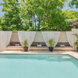 Pool with white drapes and daybeds — Casa Coco, Isla Mujeres, Mexico