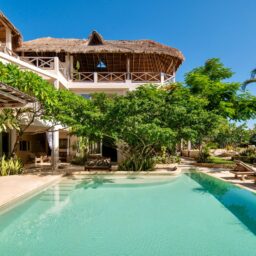 Pool and palapa rooftops — Casa Coco, Isla Mujeres, Mexico
