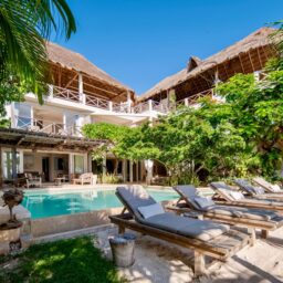 Pool, sun loungers and palapa rooftops — Casa Coco, Isla Mujeres, Mexico