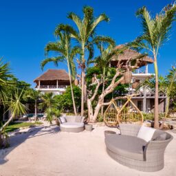 Beachfront daybed under palm trees — Casa Coco, Isla Mujeres, Mexico