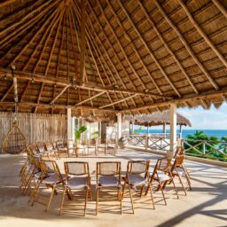 Palapa event space with round tables — Casa Coco, Isla Mujeres, Mexico