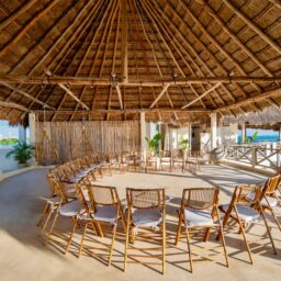 Palapa event space with round tables — Casa Coco, Isla Mujeres, Mexico