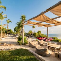 Beachfront lounge with shade sail — Casa Coco, Isla Mujeres, Mexico