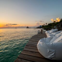 Ocean deck with bean bags at sunset — Casa Coco, Isla Mujeres, Mexico