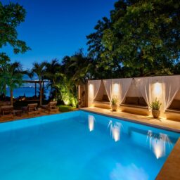 Pool with drapes at dusk — Casa Coco, Isla Mujeres, Mexico