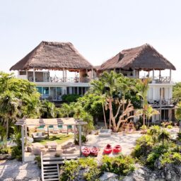 Villa exterior with palapa rooftops — Casa Coco, Isla Mujeres, Mexico