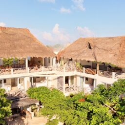Villa exterior with palapa rooftops — Casa Coco, Isla Mujeres, Mexico