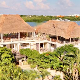 Villa exterior with palapa rooftops — Casa Coco, Isla Mujeres, Mexico