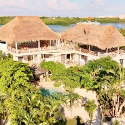 Villa exterior with palapa rooftops — Casa Coco, Isla Mujeres, Mexico