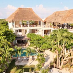 Villa exterior with pool and palm trees — Casa Coco, Isla Mujeres, Mexico