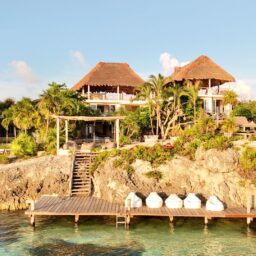 Villa and ocean dock on the rocky shore — Casa Coco, Isla Mujeres, Mexico
