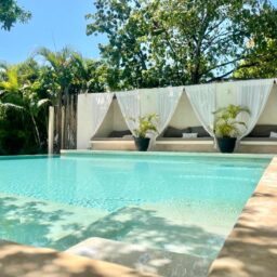 Pool with white drapes and daybeds — Casa Coco, Isla Mujeres, Mexico