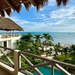Balcony view over the pool and beach — Casa Coco, Isla Mujeres, Mexico