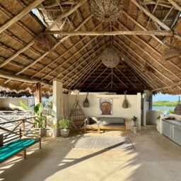 Palapa lounge with hanging chairs — Casa Coco, Isla Mujeres, Mexico