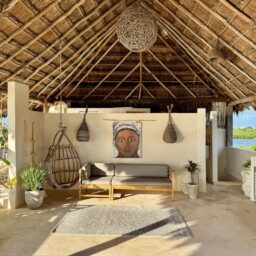 Palapa lounge with hanging chairs — Casa Coco, Isla Mujeres, Mexico