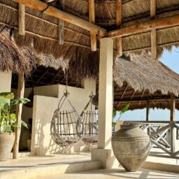 Palapa lounge with hanging chairs — Casa Coco, Isla Mujeres, Mexico