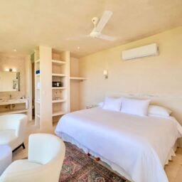 Bedroom with bed and shelving — Casa Coco, Isla Mujeres, Mexico