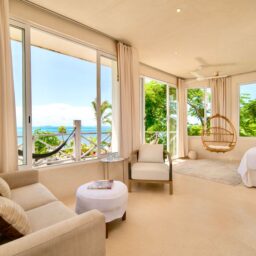 Bedroom with ocean-view windows — Casa Coco, Isla Mujeres, Mexico