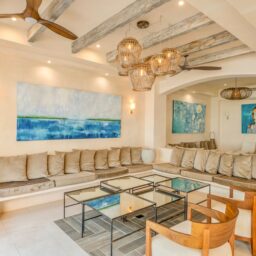 Living room with built-in sofa and artwork — Casa Lola, Isla Mujeres, Mexico