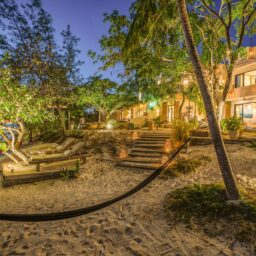 Garden steps and hammock at dusk — Casa Lola, Isla Mujeres, Mexico