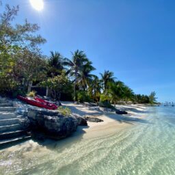 Beach with stone steps and kayaks — Casa Lola, Isla Mujeres, Mexico
