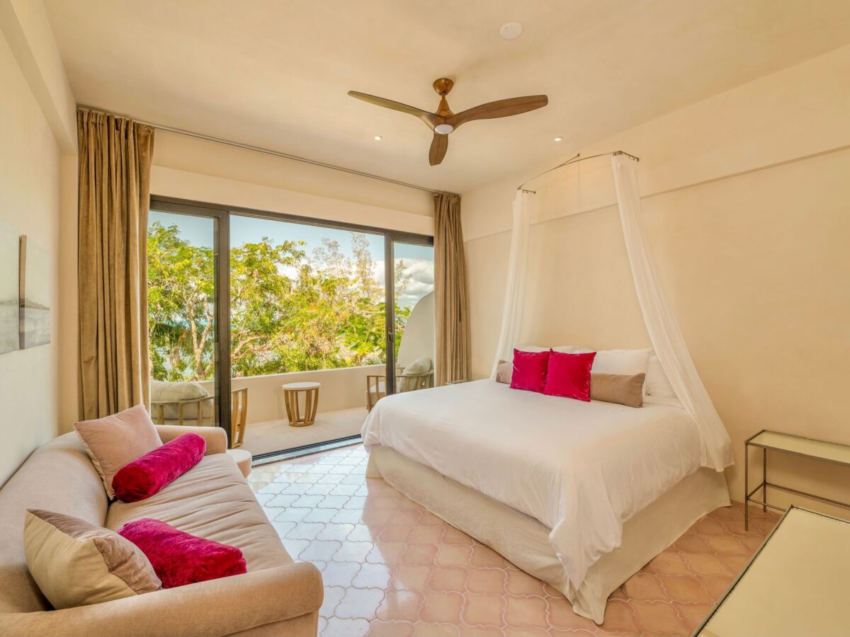 Bedroom with canopy bed and sofa — Casa Lola, Isla Mujeres, Mexico