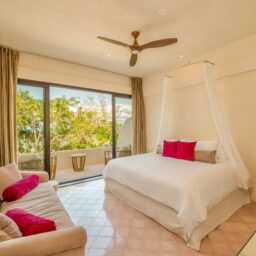 Bedroom with canopy bed and sofa — Casa Lola, Isla Mujeres, Mexico