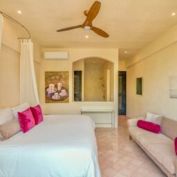 Bedroom with canopy bed and sitting area — Casa Lola, Isla Mujeres, Mexico