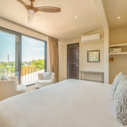 Bedroom with ceiling fan and sitting area — Casa Lola, Isla Mujeres, Mexico