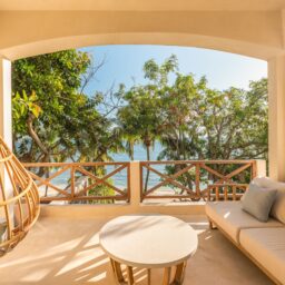 Balcony with hanging chair and ocean view — Casa Lola, Isla Mujeres, Mexico