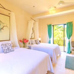 Bedroom with two beds and canopy — Villa Encantada, Isla Mujeres, Mexico