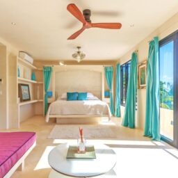 Bedroom with bed and shelving — Villa Encantada, Isla Mujeres, Mexico